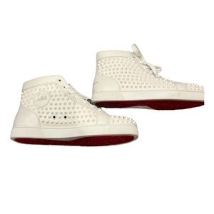 All white Christian Louboutin spikes
